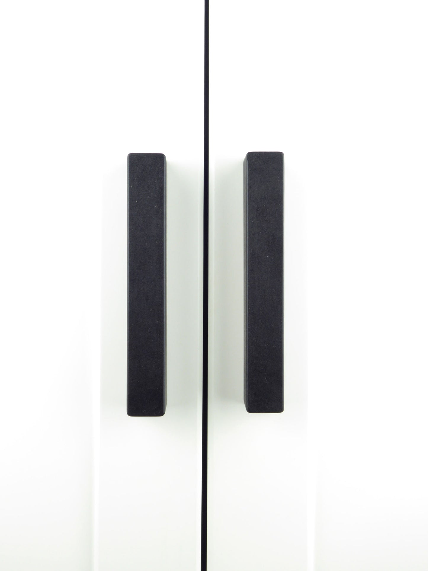 A pair of hand crafted wooden wardrobe handles in matt black