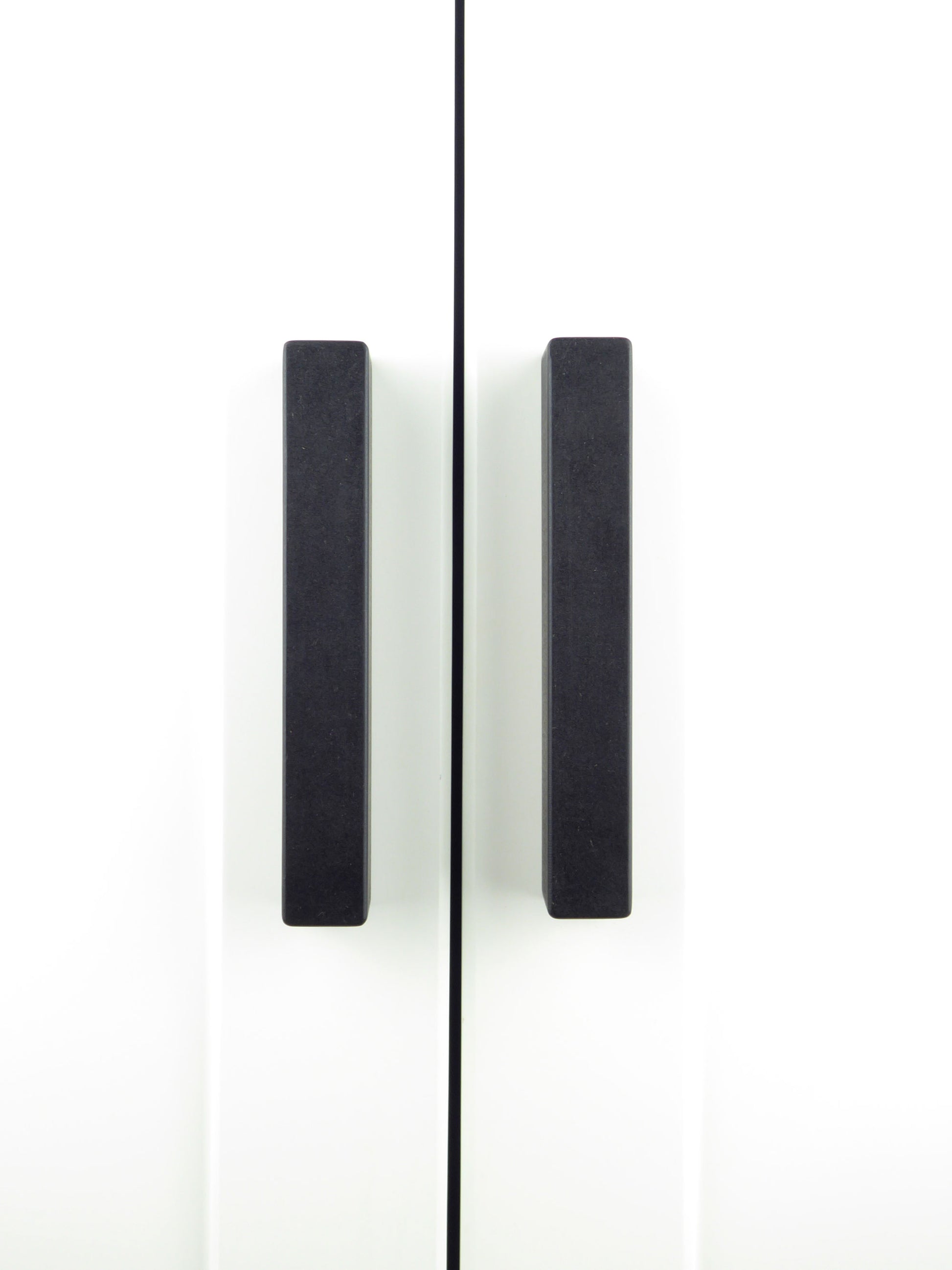 A pair of hand crafted wooden wardrobe handles in matt black