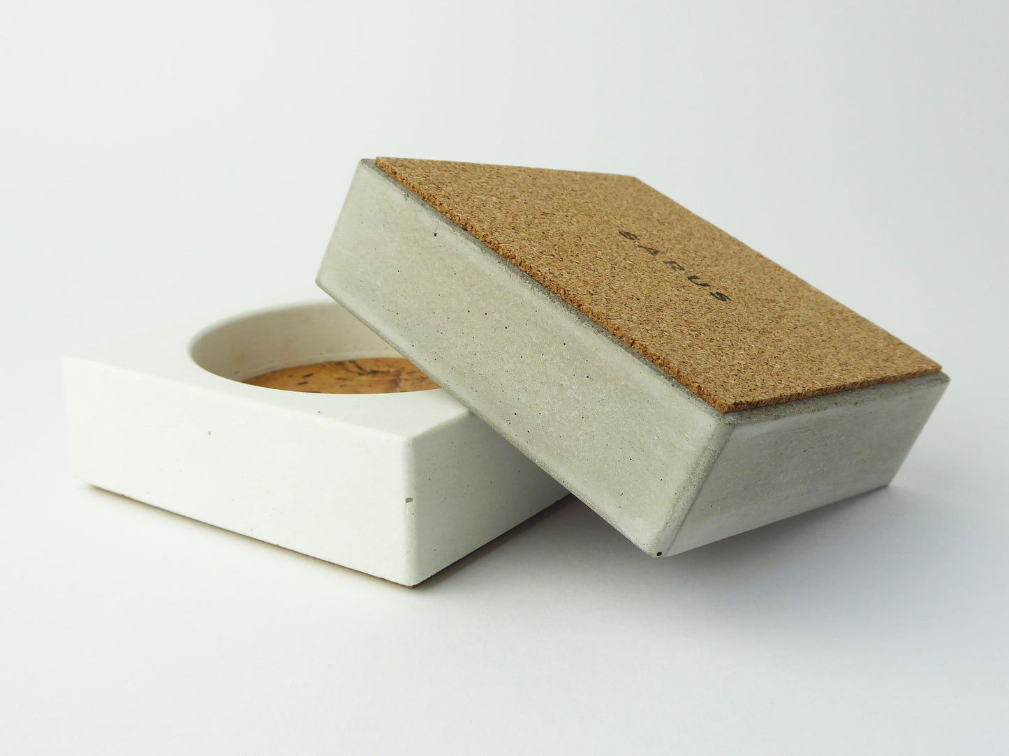 Concrete jewellery tray with a cork base to protect surfaces.