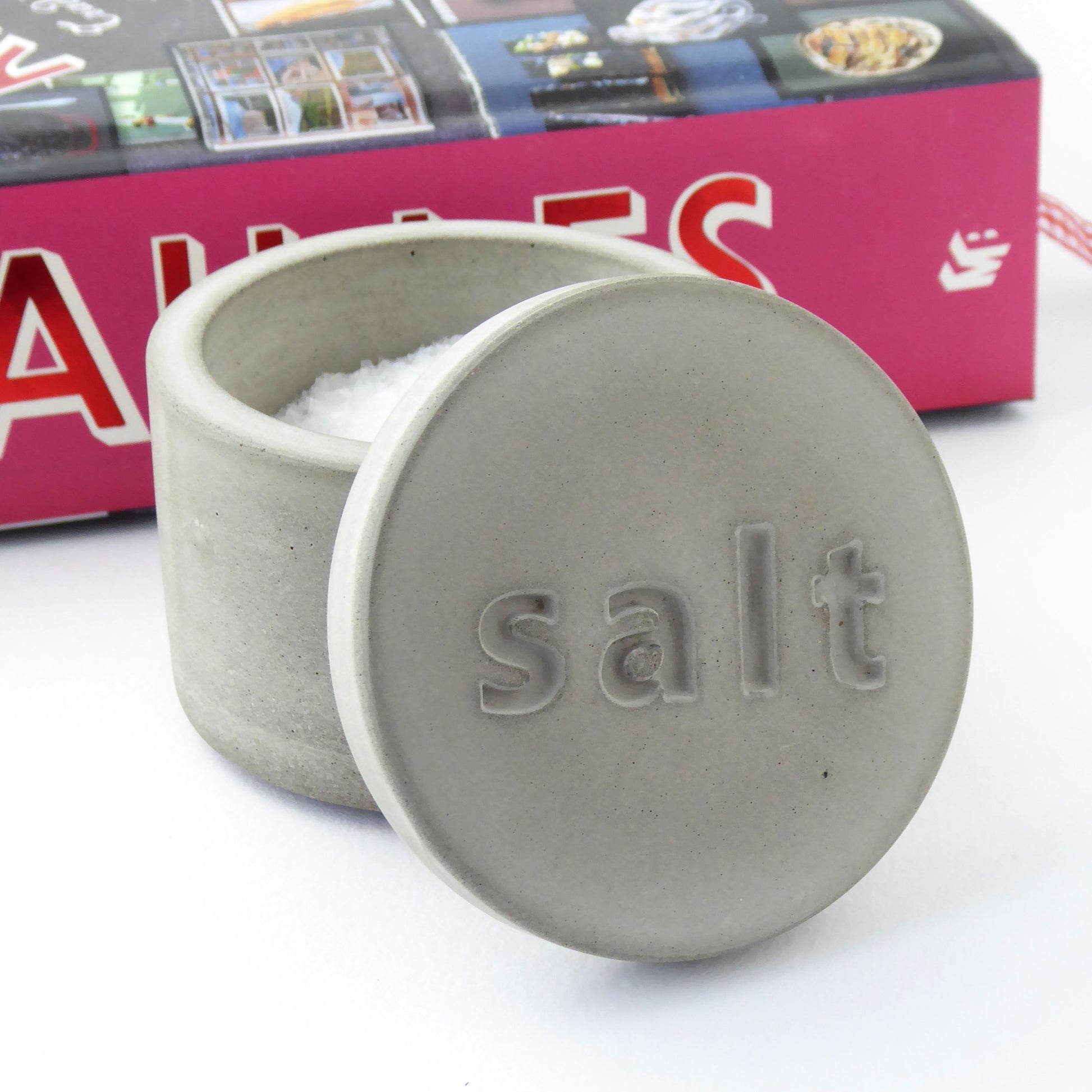 Natural grey concrete salt container with 'salt' engraved on the lid