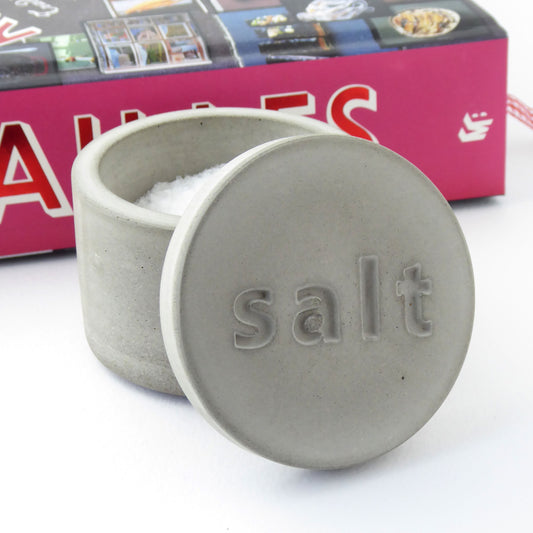 Natural grey concrete salt container with 'salt' engraved on the lid