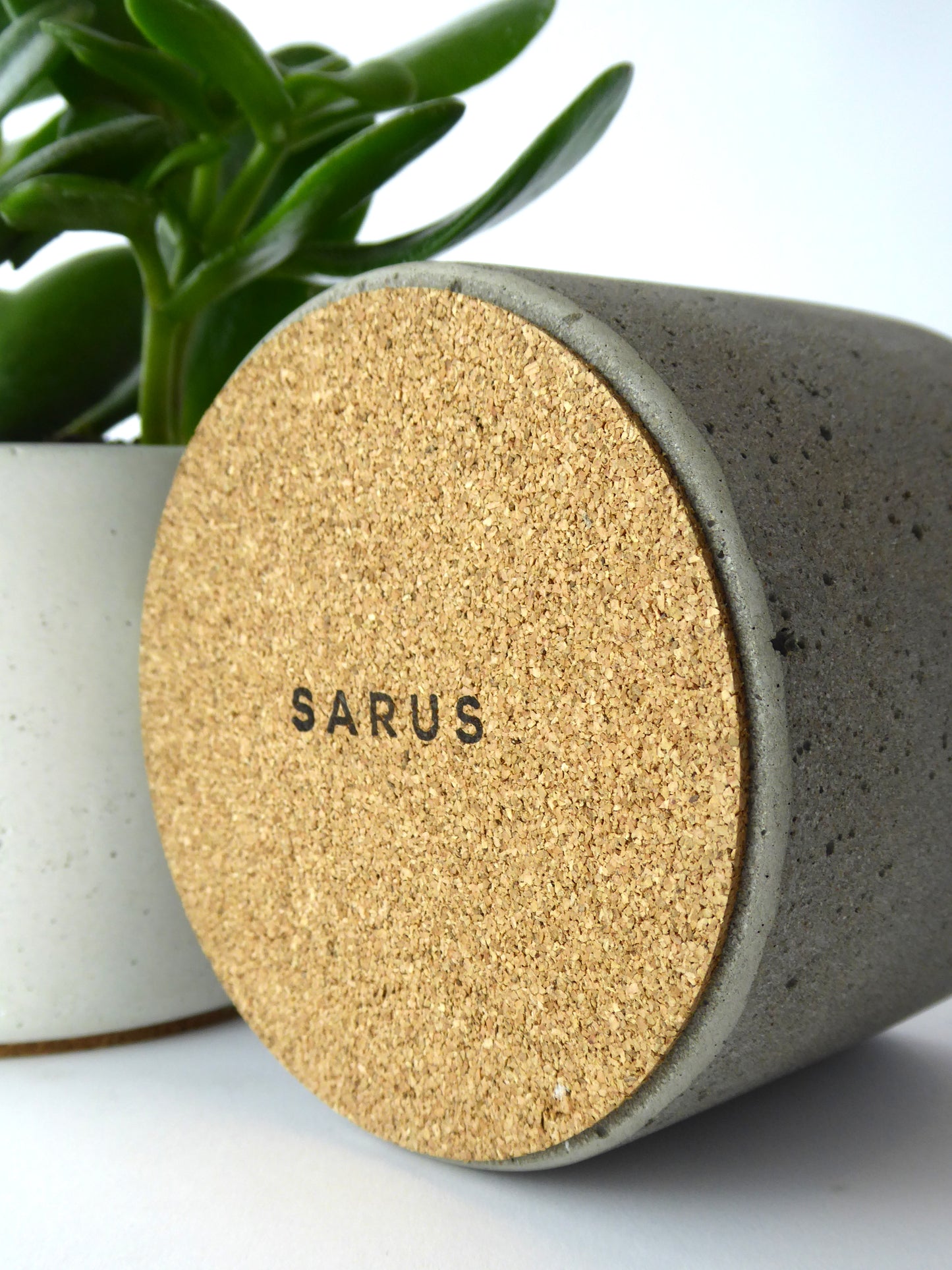 Cork base with a SARUS stamped logo of a concrete plant pot