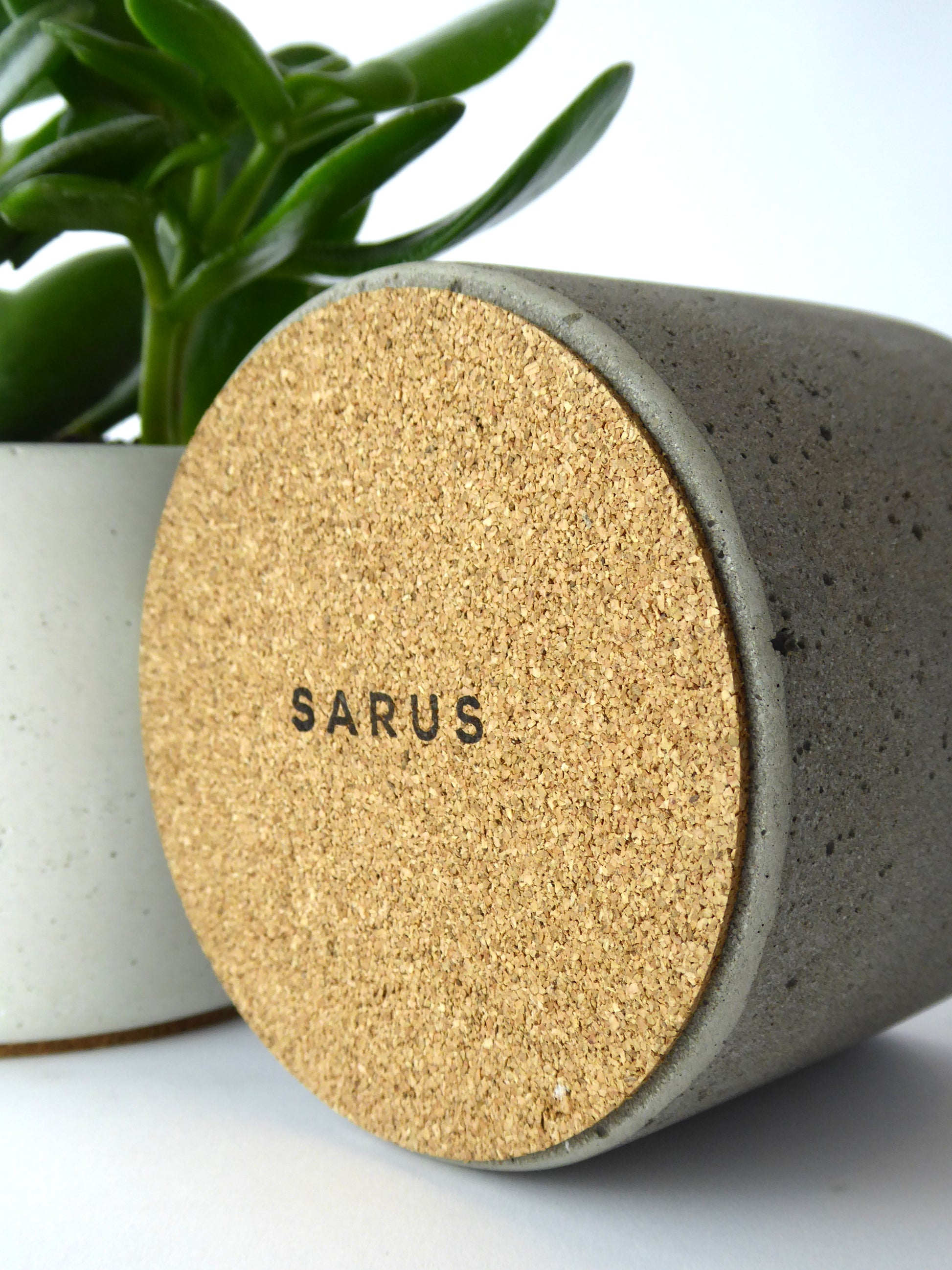 Cork base with a SARUS stamped logo of a concrete plant pot