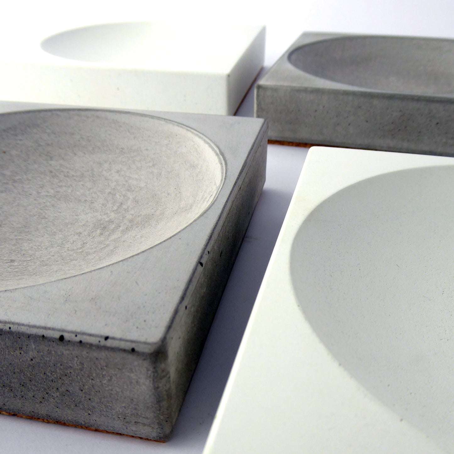 White and grey concrete trays on a white background