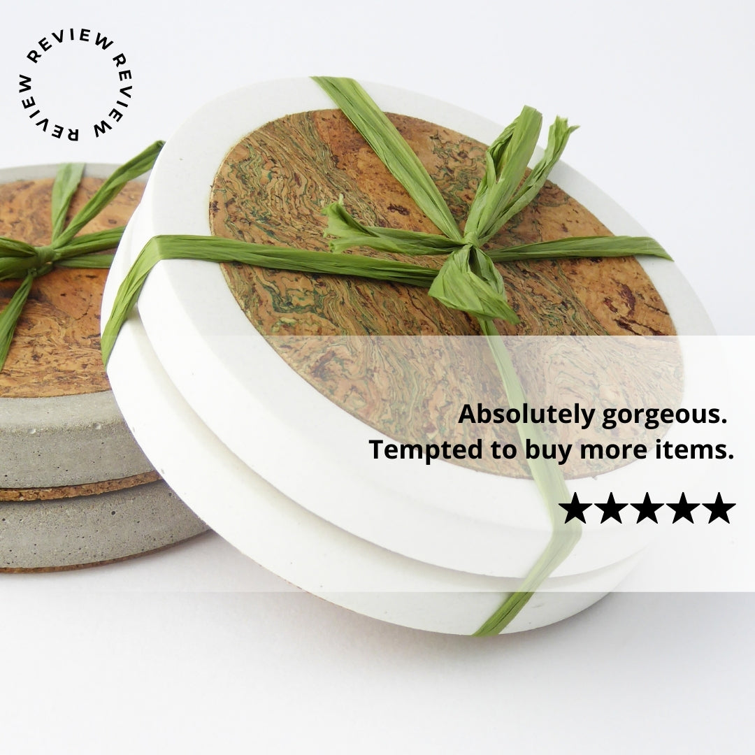 Set of cork coasters tie with decorative raffia on a white background, with positive 5 star review text.