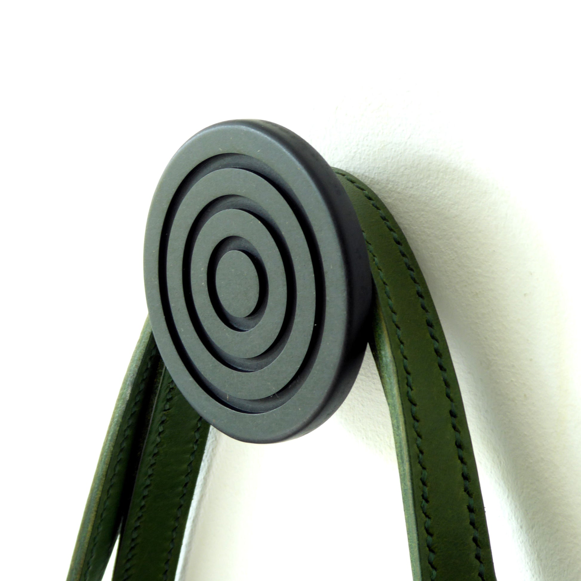 Wall mounted black wooden wall hook with an embossed spiral design