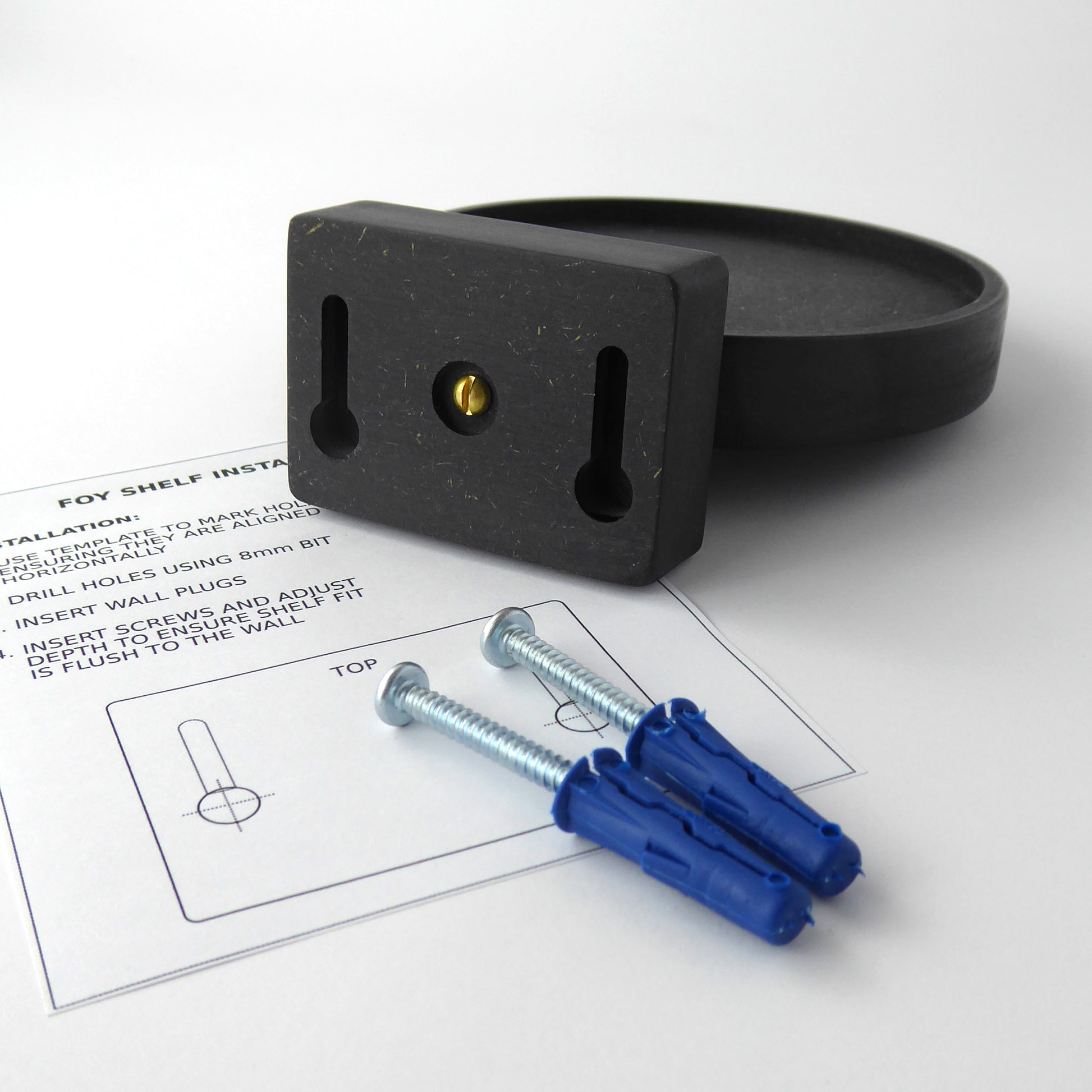 black wall mounted display shelf and instructions to show how to mount it and the screws and wall plugs needed to mount it