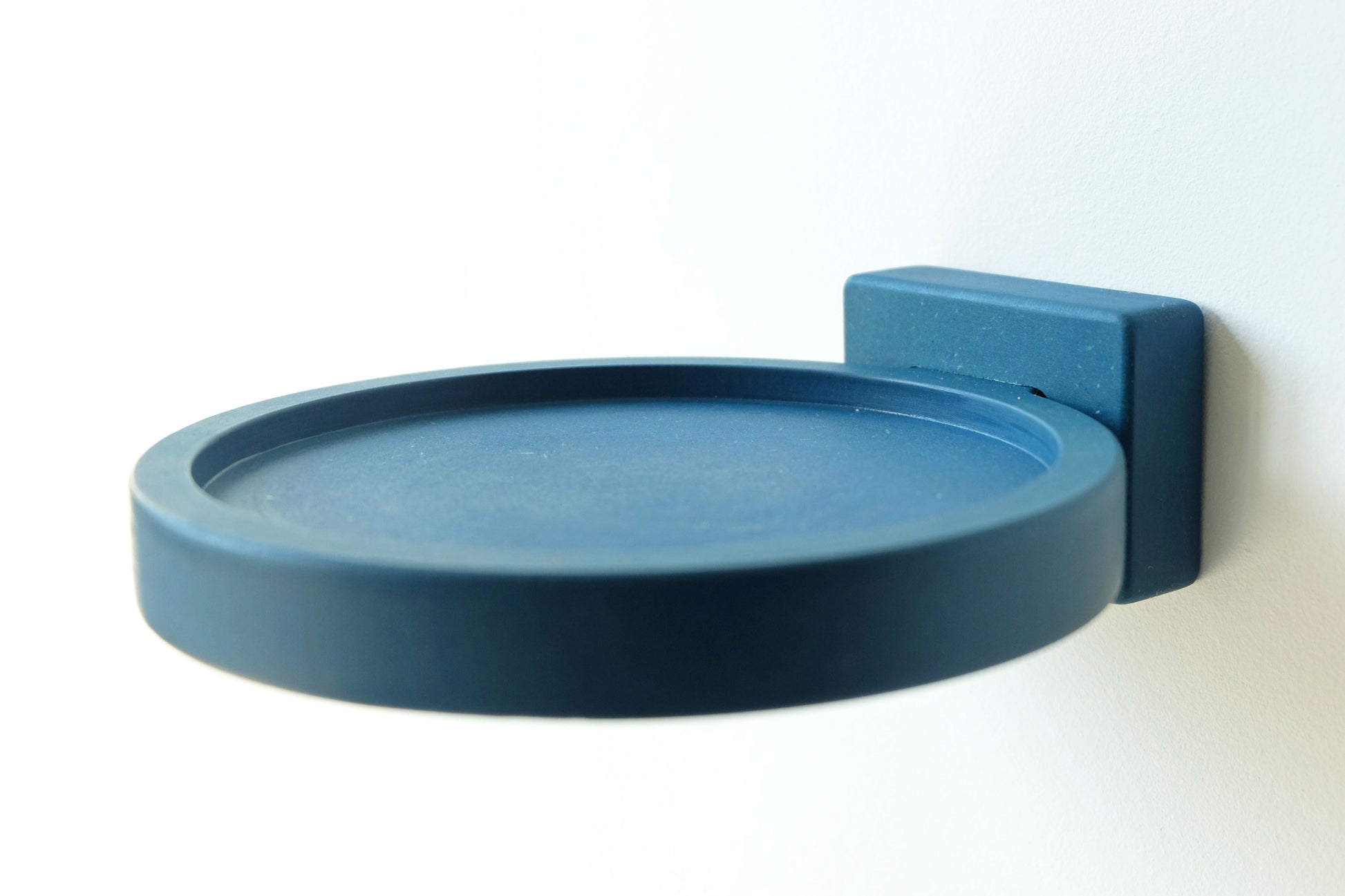 Blue wood display shelf mounted to the wall