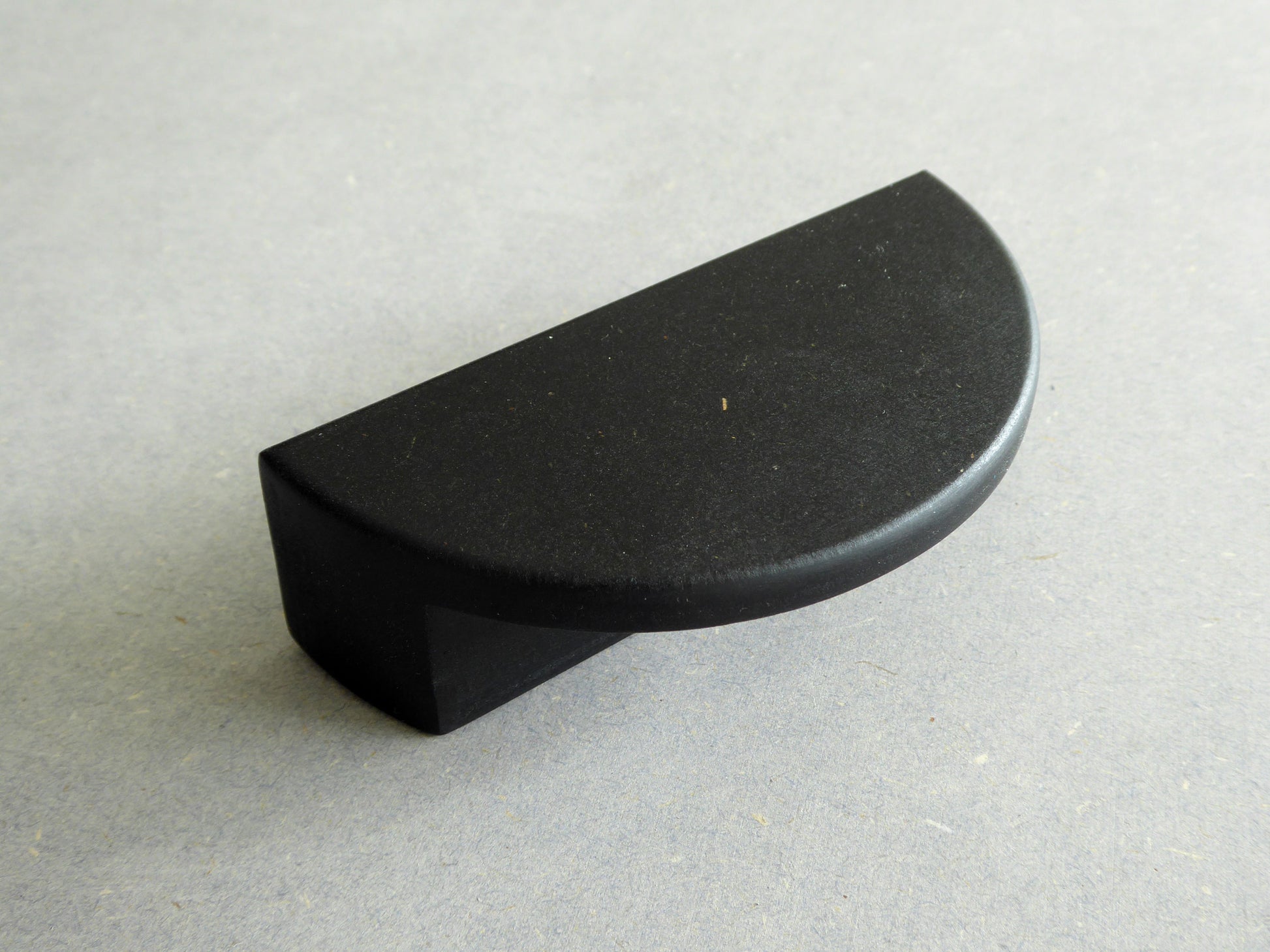 black drawer pull in half moon shape