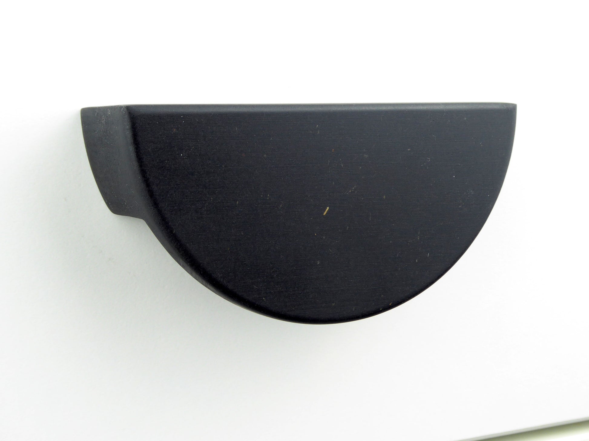 A minimalist black cabinet drawer handle