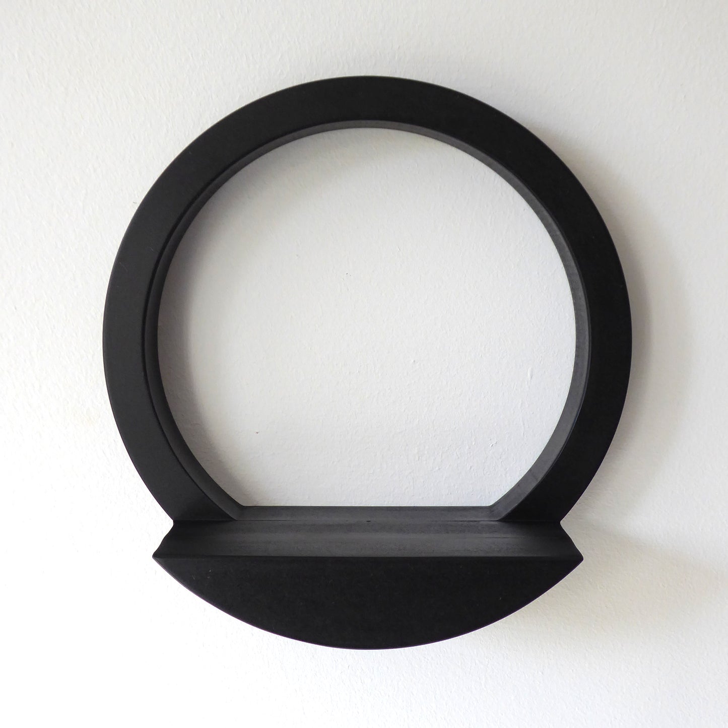 Wall mounted circular display shelf in black wood