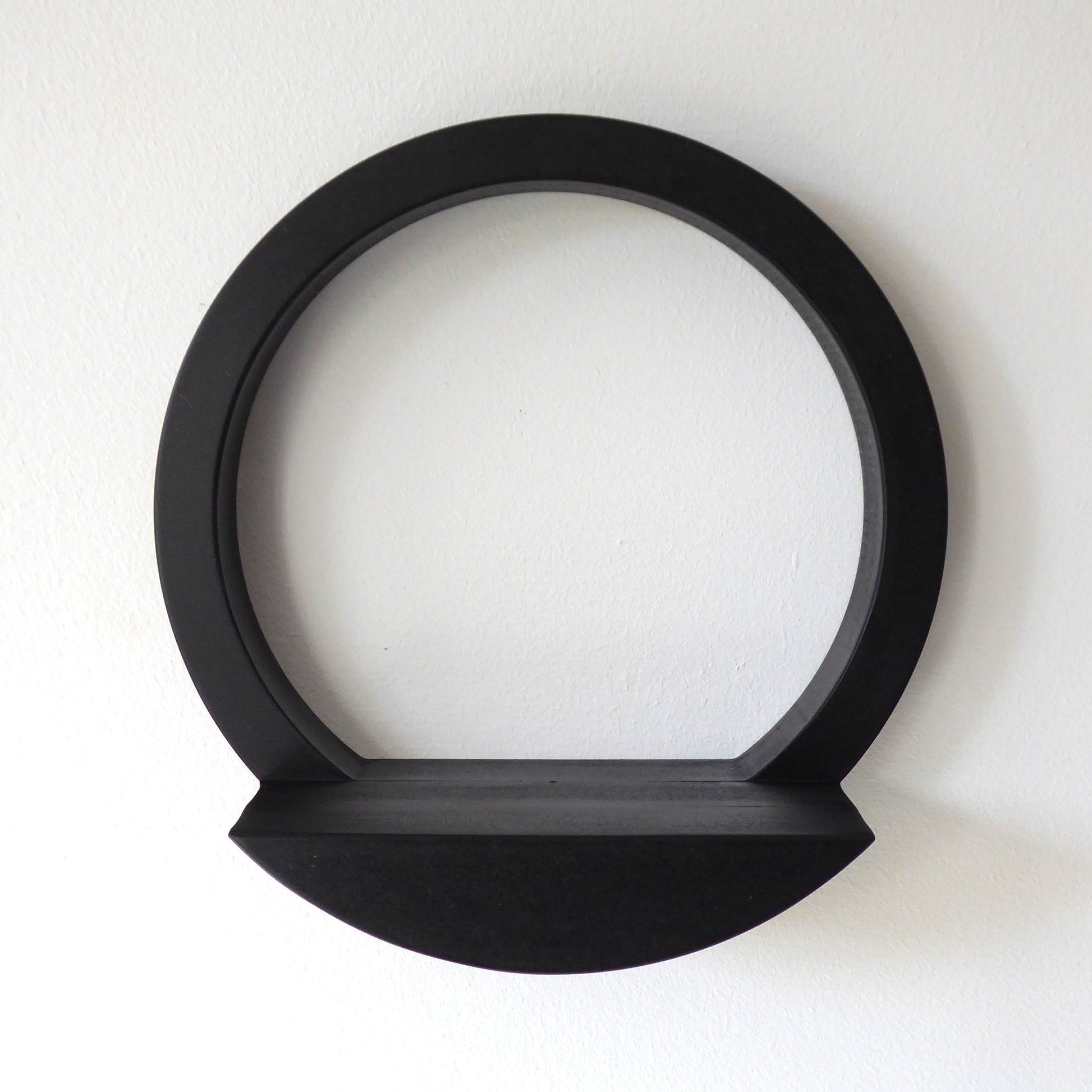 Wall mounted circular display shelf in black wood