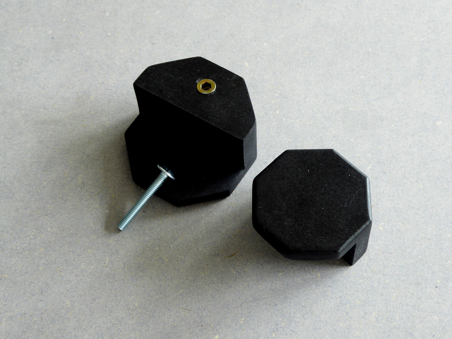 Black drawer know with a fixing screw for easy installation