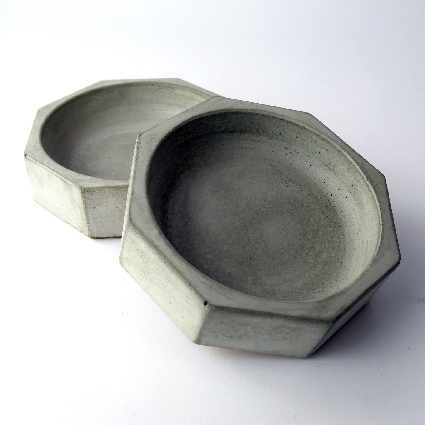 Grey concrete bowls on a white background