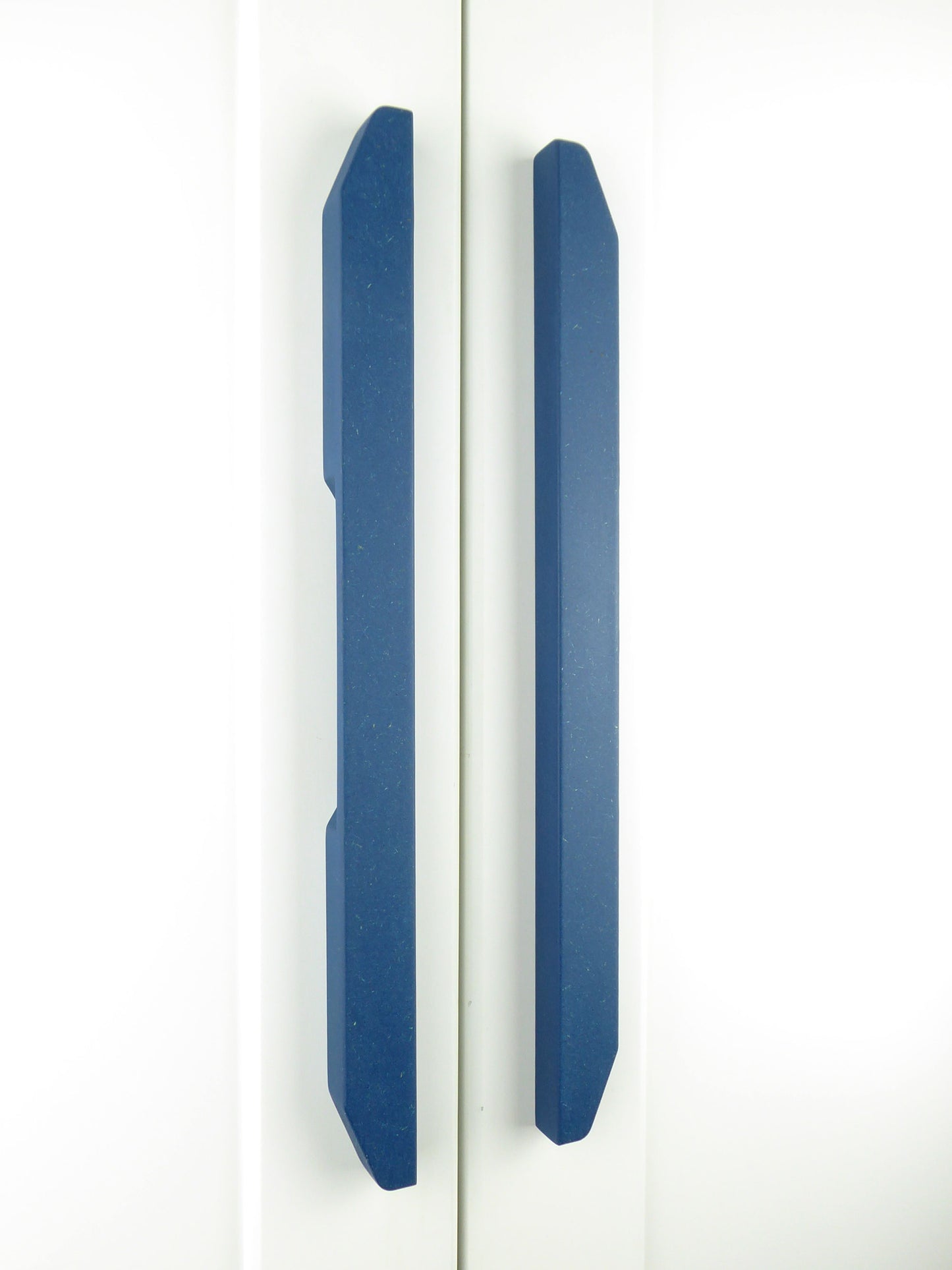 A set of modern blue wooden kitchen cabinet pulls