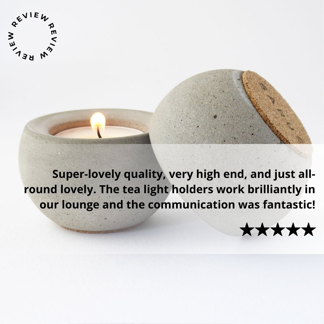 Ceramic tea light holder with a lit candle on a white background, surrounded by positive review text.