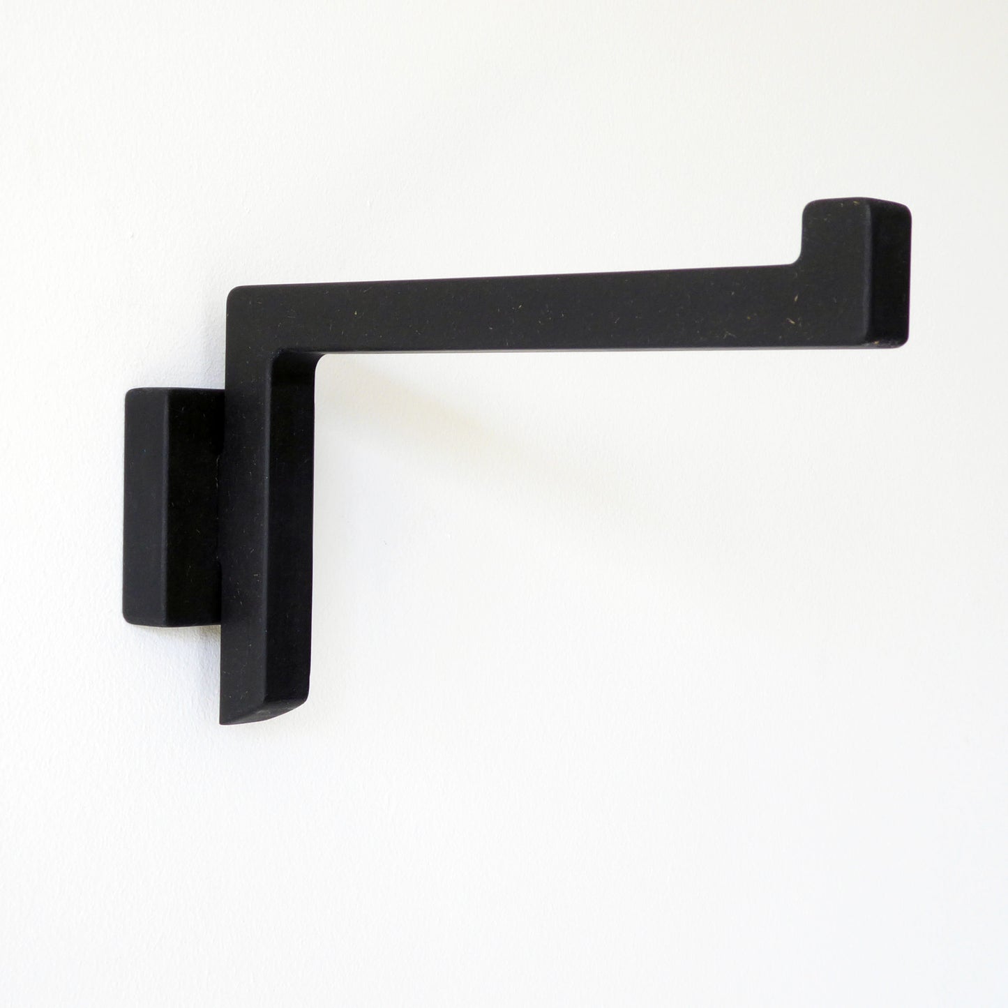 Black wall mounted bracket for hanging a pendant lamp