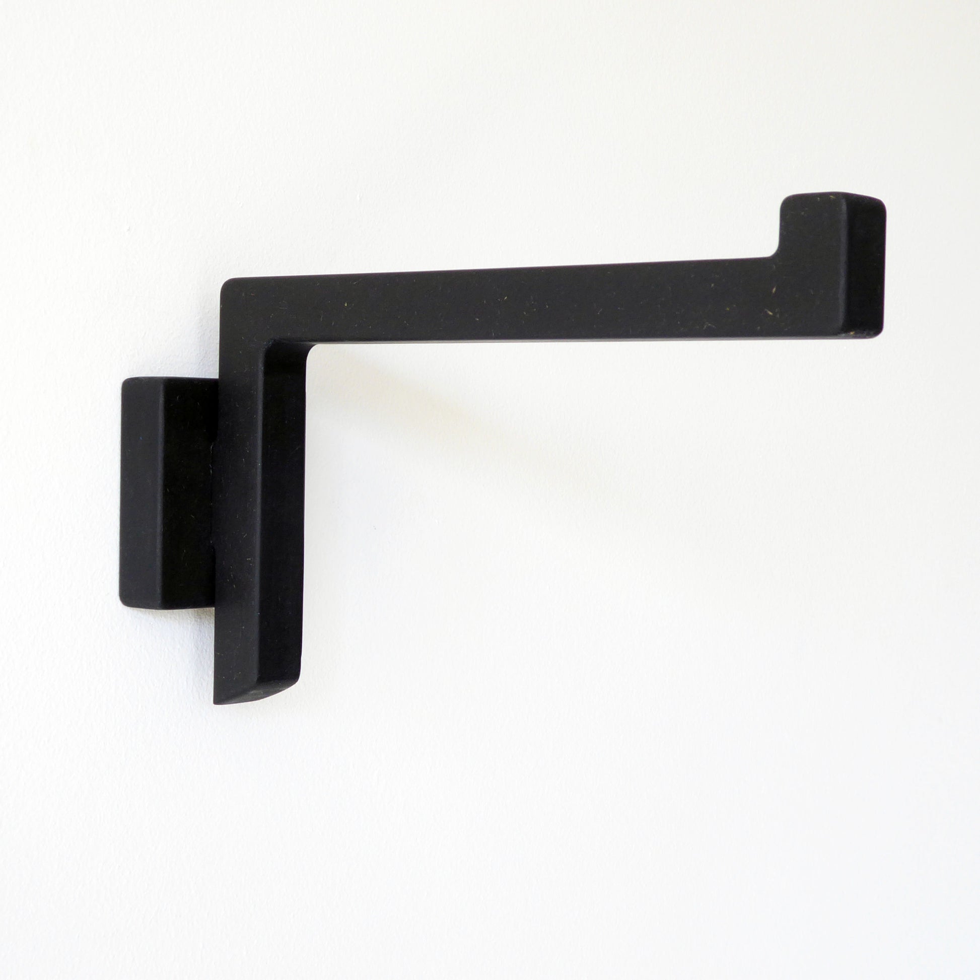 Black wall mounted bracket for hanging a pendant lamp