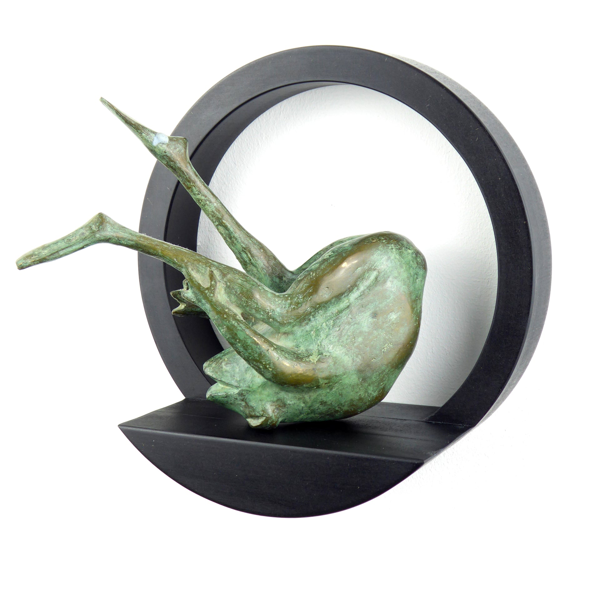 A circular black wooden display shelf mounted on a wall, featuring a unique frog ornament on it.