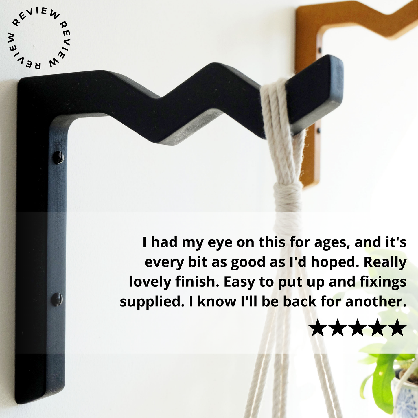 Wooden wall mounted plant hangers on a white wall with a 5 star review