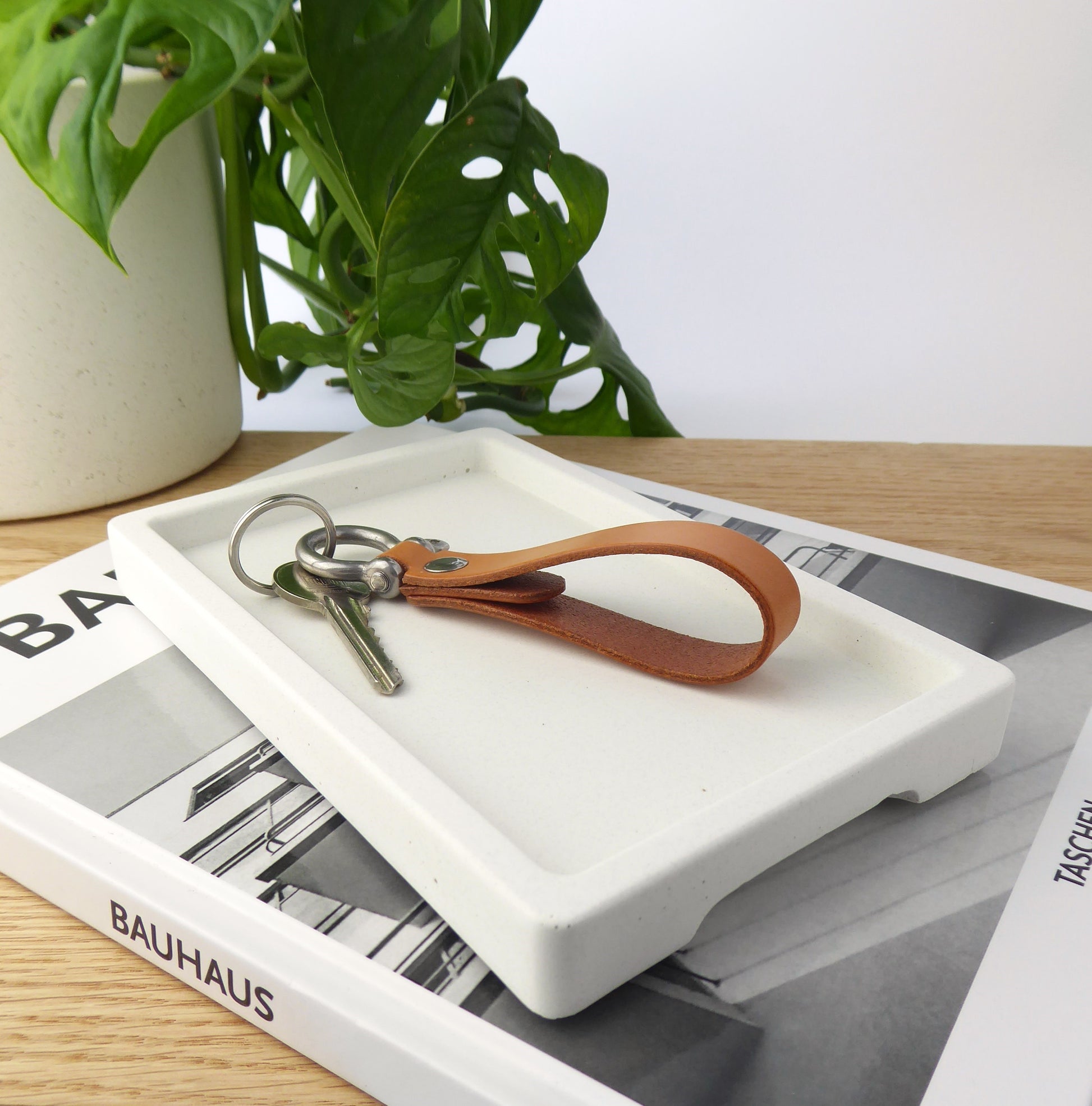 White ceramic tray holding keys on hallway table