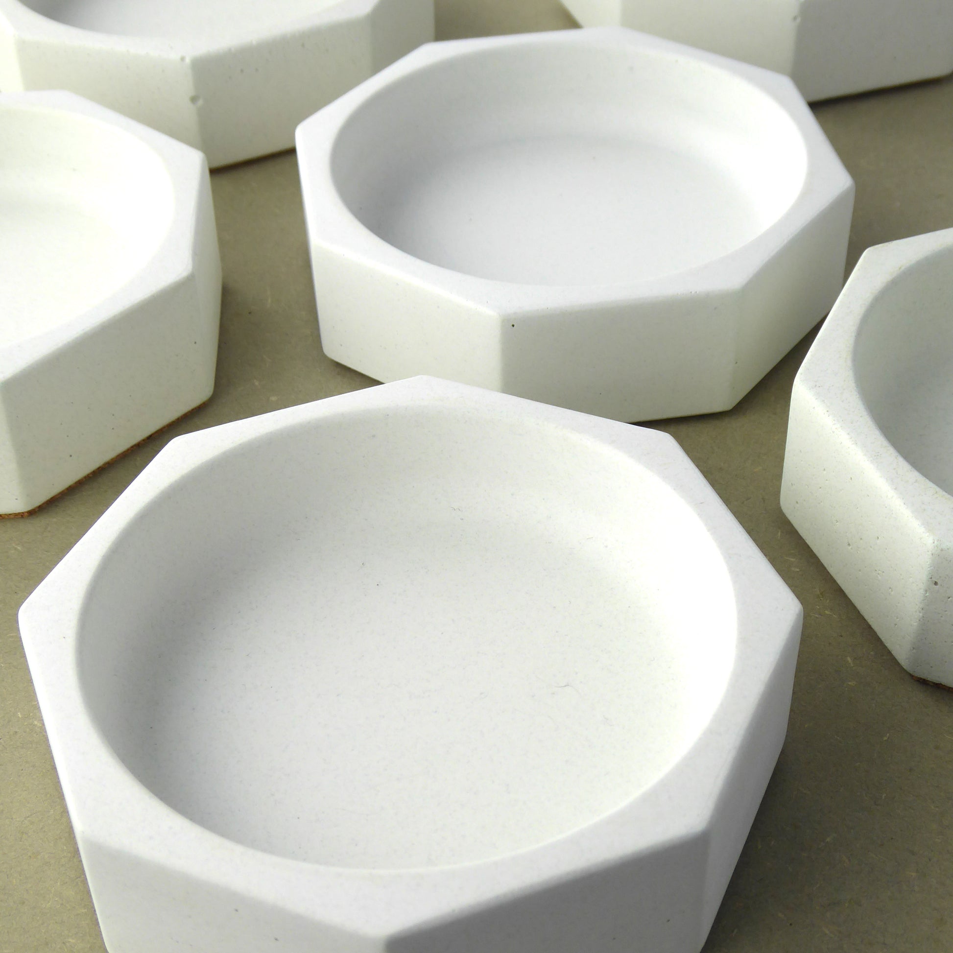 White concrete bowls with a hexagon shape on a shelf