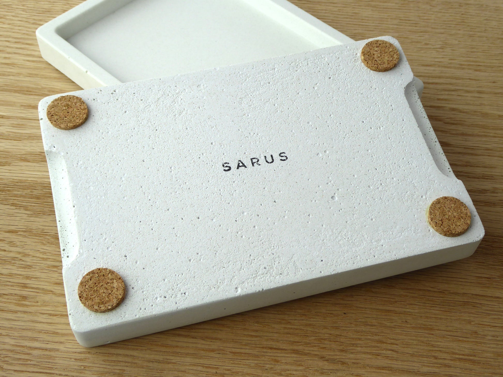 White rectangular concrete tray showing the base with cork pads to protect surfaces