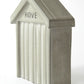 Small grey concrete beach hut with 'HOVE' embossed in the design on a white background