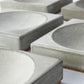 Grey concrete square trays showing the unique texture and tone of hand poured concrete