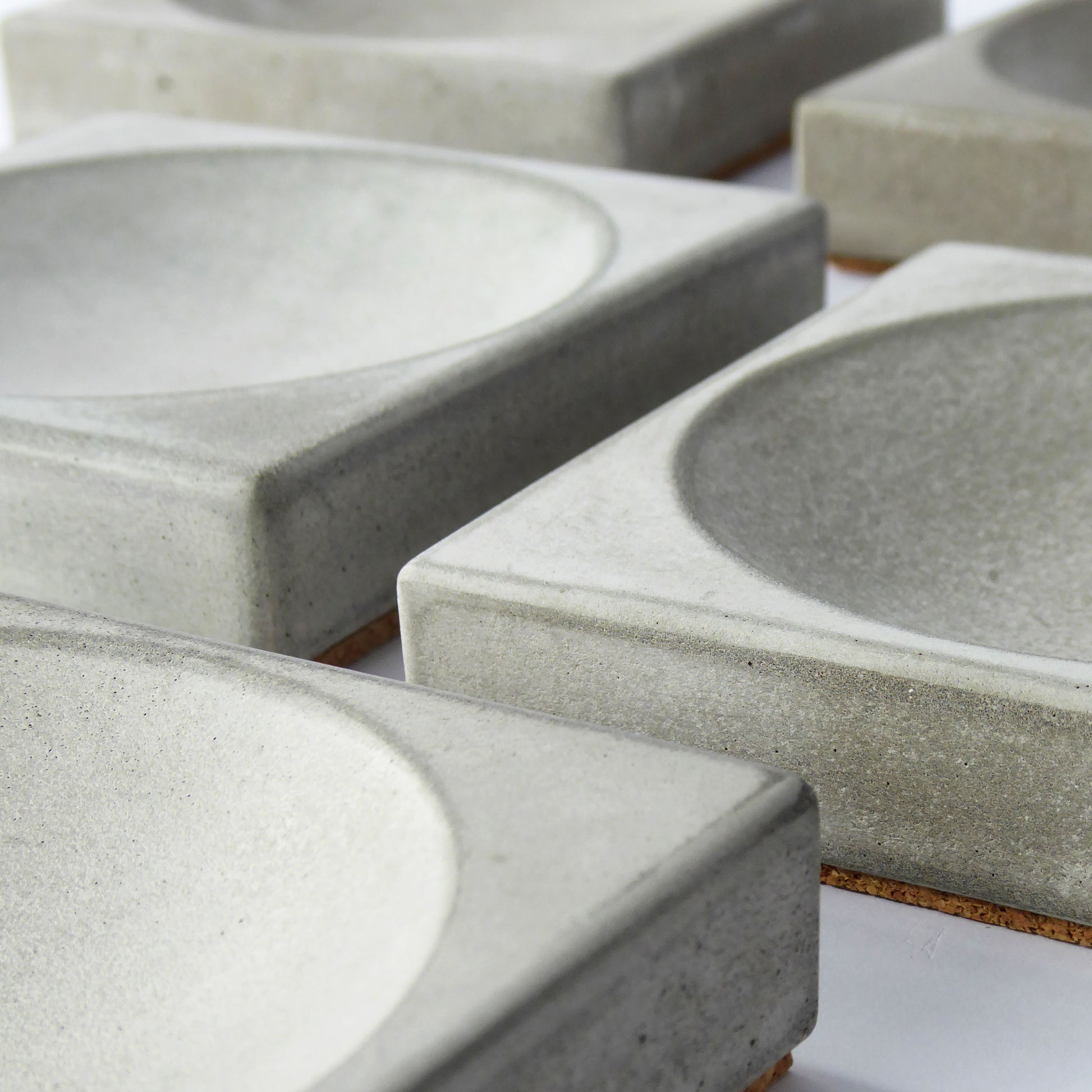 Grey concrete square trays showing the unique texture and tone of hand poured concrete