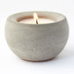 Candle in a concrete holder on a white background