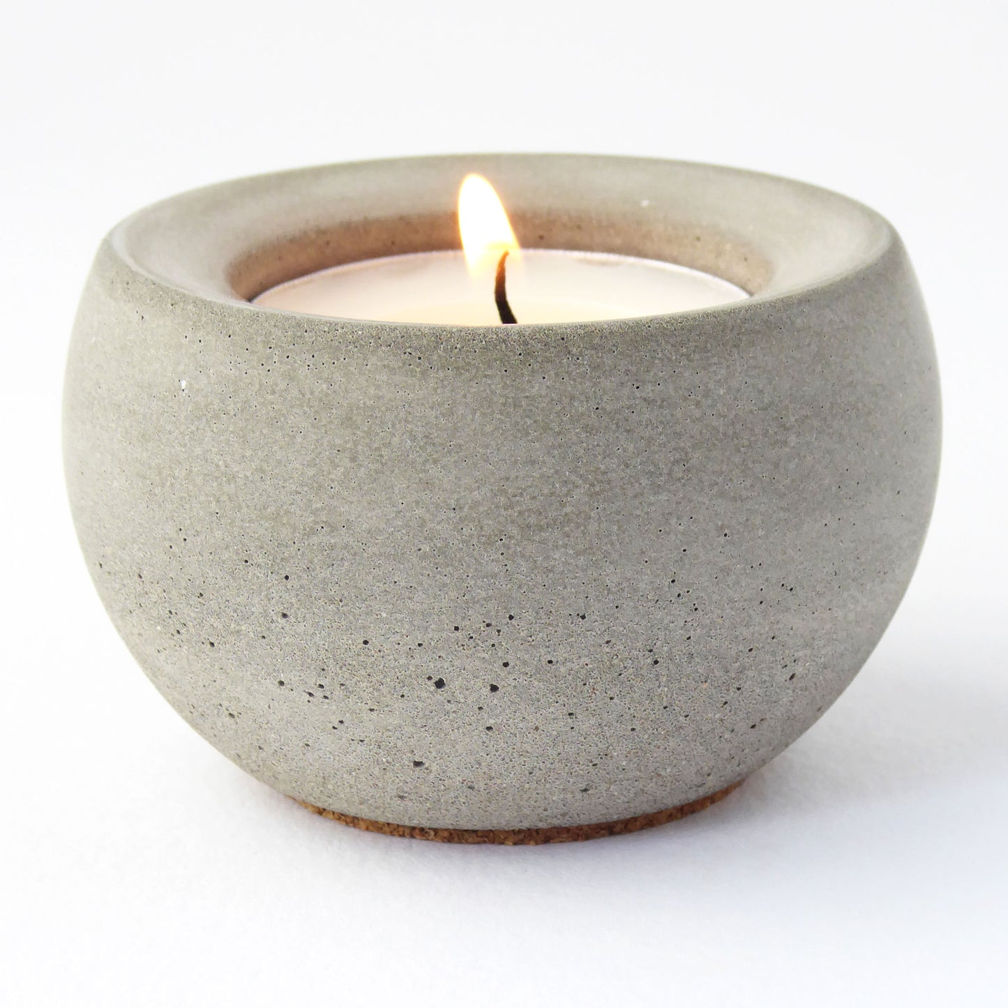 Candle in a concrete holder on a white background