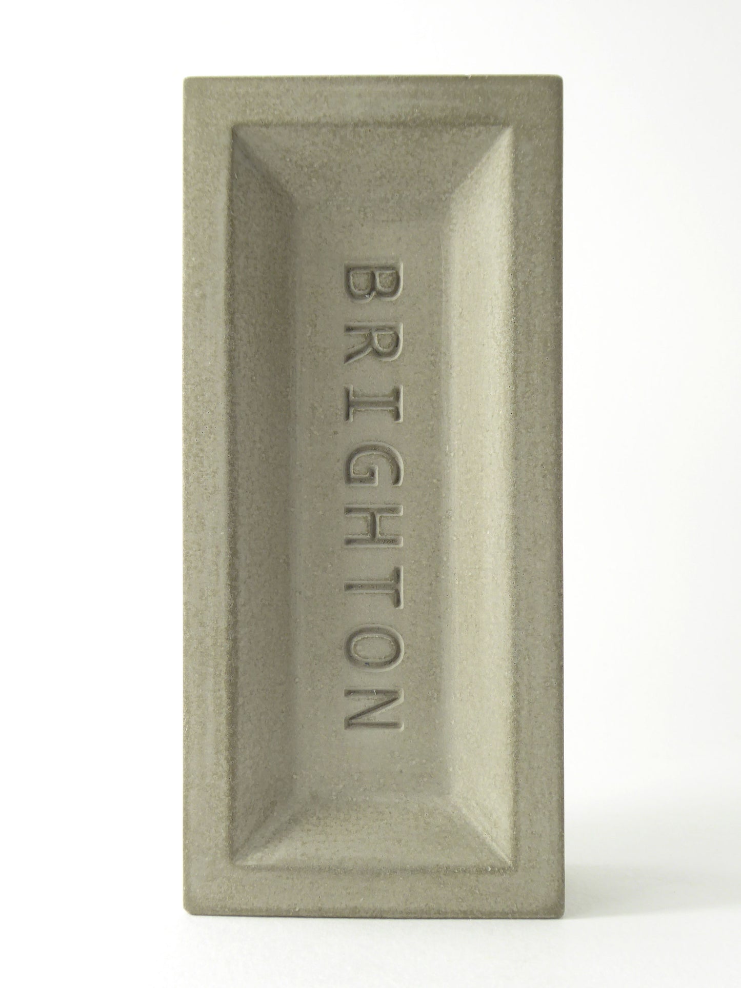 Rectangular concrete decorative brick with 'Brighton' engraved on it
