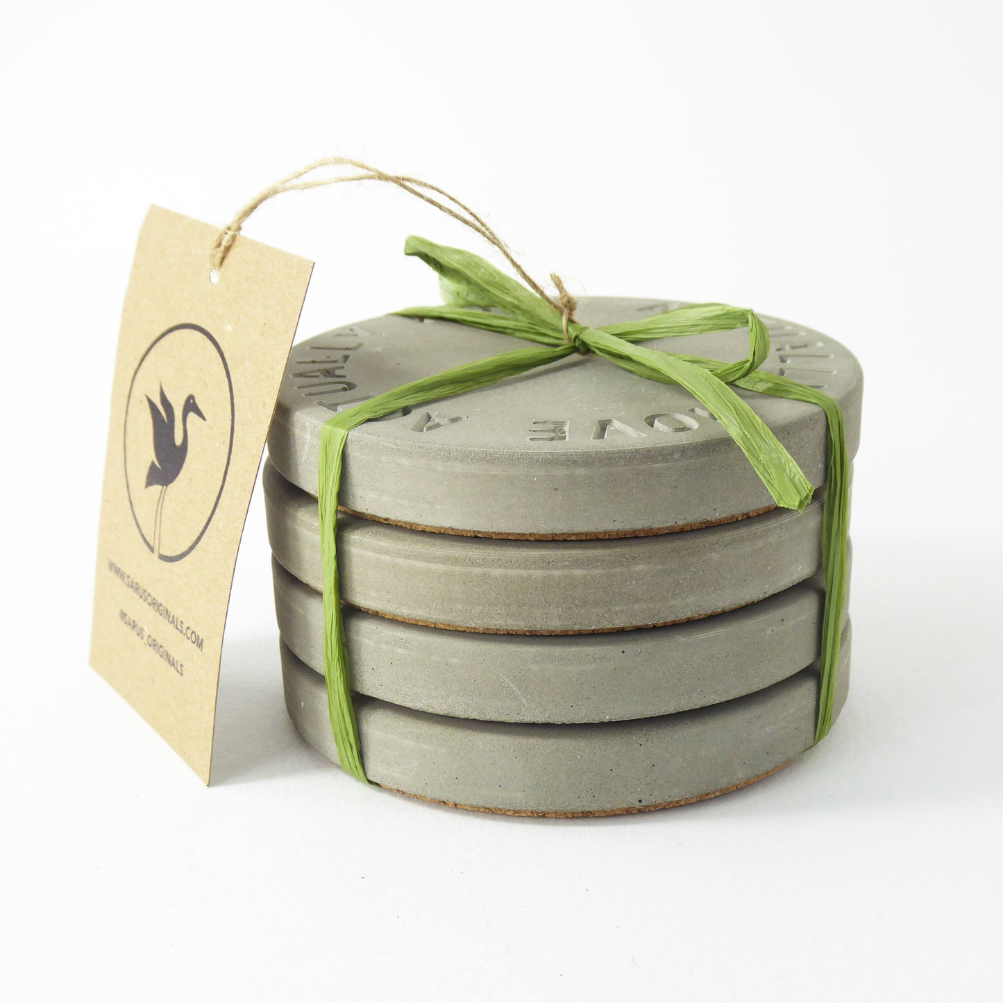 Set of 4 gray concrete coasters tied with green raffia and a logo tag