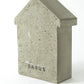 The back of a concrete beach hut with 'SARUS' logo imprinted