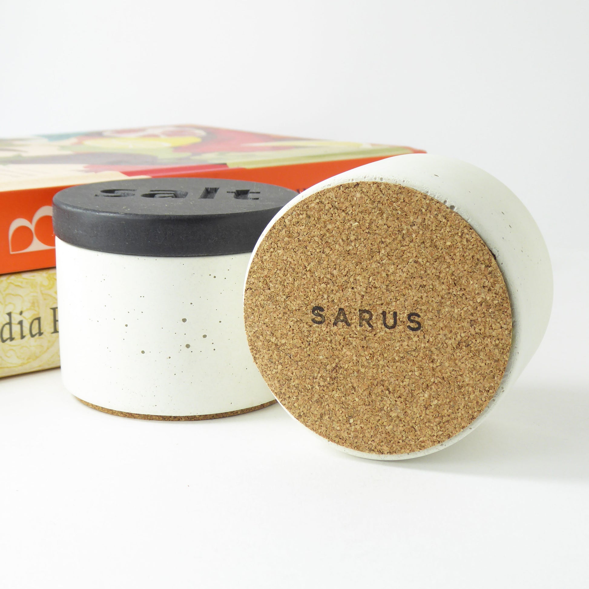 Concrete pots with wooden lids and the base of one pot showing the cork base to protect surfaces