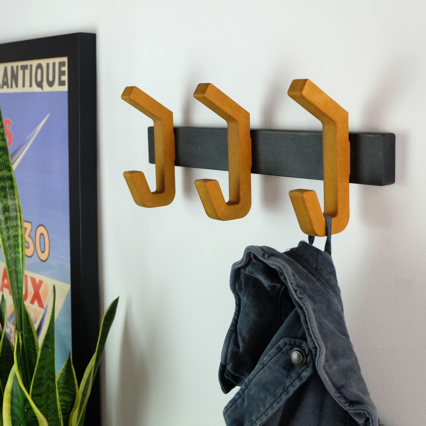 yellow wooden coat rack with matt black wall bracket